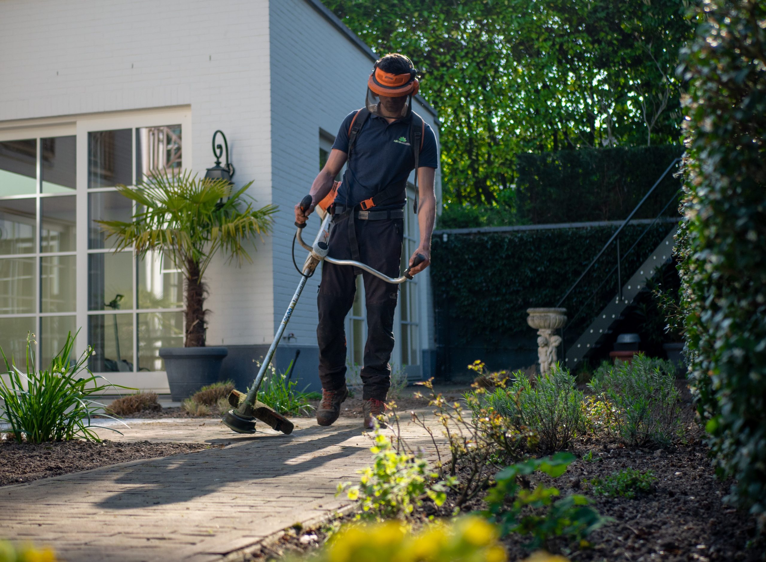 lawn care worker using an edger